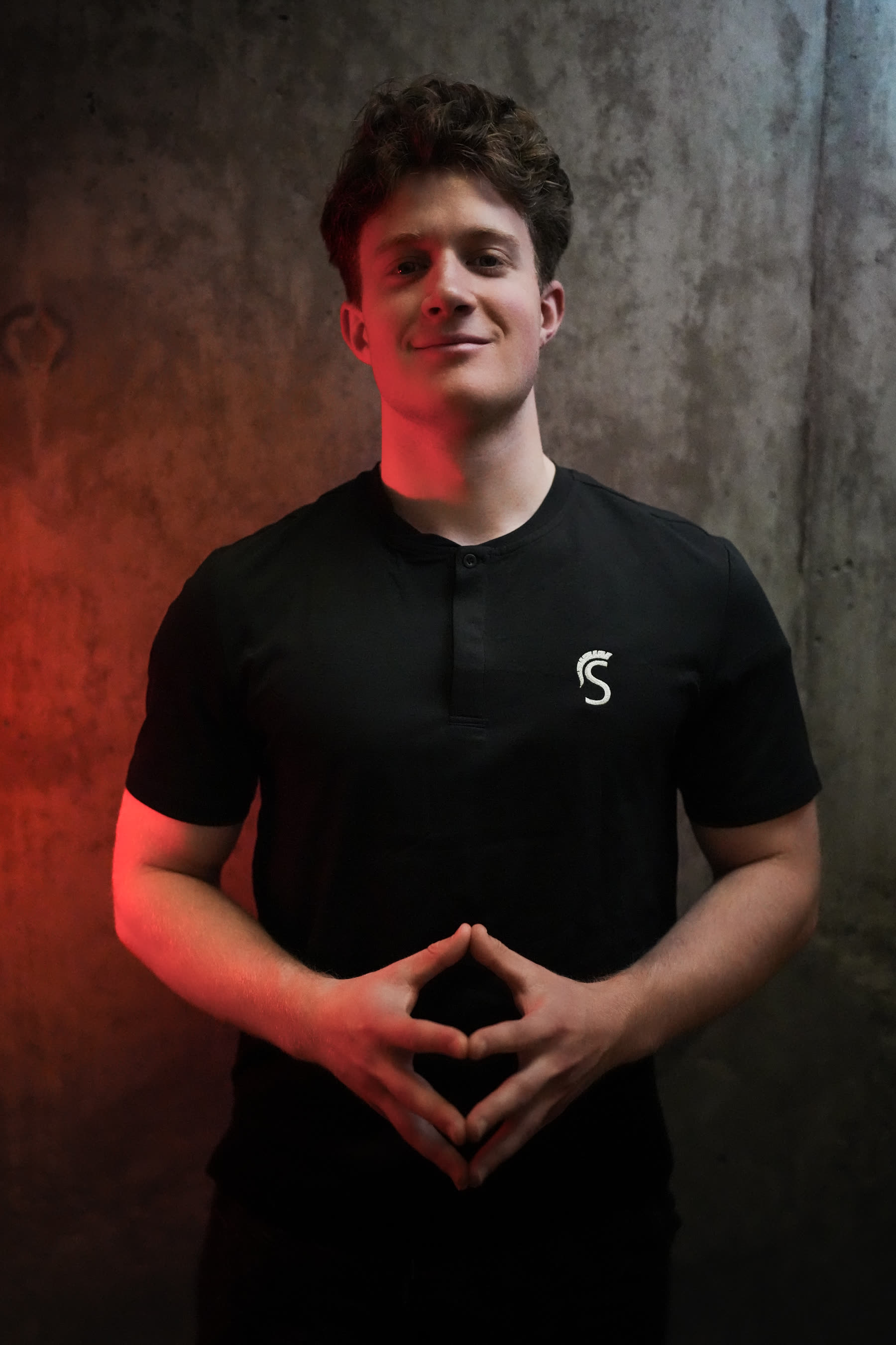 Brand portrait, red studio lighting on concrete